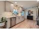 Modern kitchen featuring stainless steel appliances, light countertops, stylish cabinetry, and wood floors at 6642 S Pearl St, Centennial, CO 80121