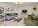 Stylish living room featuring modern decor, comfortable seating, a glass coffee table, and a contemporary light fixture at 6642 S Pearl St, Centennial, CO 80121