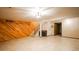 Spacious basement recreation area with wood paneling and stairs at 1770 Robb St, Lakewood, CO 80215