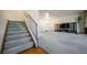 Bright living room with staircase, hardwood floors, and a fireplace at 1770 Robb St, Lakewood, CO 80215