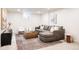 Basement featuring a large gray sectional and a patterned rug at 3624 S Poplar St, Denver, CO 80237