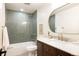 Bathroom featuring a shower over tub, and a marble countertop with gold hardware at 3624 S Poplar St, Denver, CO 80237