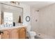 Modern bathroom featuring a double vanity and a stylish walk-in shower at 3624 S Poplar St, Denver, CO 80237