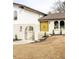 Inviting front entrance with bright yellow double doors, arched entry, and manicured landscaping at 3624 S Poplar St, Denver, CO 80237