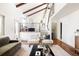 Open-concept living room featuring a staircase, and hardwood floors at 3624 S Poplar St, Denver, CO 80237