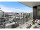 Balcony with seating offering views of city buildings and distant mountains at 155 Steele St # 917, Denver, CO 80206