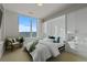 Bedroom featuring a murphy bed, built-in storage, carpet, and city views from a large window at 155 Steele St # 917, Denver, CO 80206