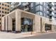 Upscale condo building entrance featuring modern architecture with elegant stone details and inviting glass doors at 155 Steele St # 917, Denver, CO 80206