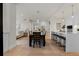 Bright, modern dining area with wood floors and an open floor plan to the kitchen and living room at 155 Steele St # 917, Denver, CO 80206