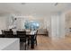 Bright dining room with modern light fixture open to living area at 155 Steele St # 917, Denver, CO 80206