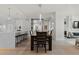 Dining area with open kitchen and dark wooden table and chairs at 155 Steele St # 917, Denver, CO 80206