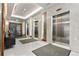 Elegant elevator lobby showcasing marble accents, floor mats, and stainless steel elevators at 155 Steele St # 917, Denver, CO 80206