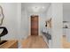 Spacious entryway features a wooden door, built-in bench, and leads to the kitchen at 155 Steele St # 917, Denver, CO 80206