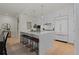 A modern white kitchen features a large island with bar seating and pendant lighting at 155 Steele St # 917, Denver, CO 80206