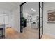 Bright home office space featuring custom white cabinetry and hardwood floors seen through modern glass doors at 155 Steele St # 917, Denver, CO 80206