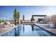 Stunning rooftop pool with lounge chairs, lush landscaping, and scenic city views at 155 Steele St # 917, Denver, CO 80206