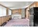 Spacious basement area with brick accents, weight bench, and exterior access door at 8991 Hickory Pl, Thornton, CO 80229