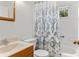 Functional bathroom featuring a tub, patterned shower curtain, and a vanity with sink at 8991 Hickory Pl, Thornton, CO 80229