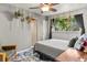 Cozy bedroom with ceiling fan, area rug, and hanging potted plants from the window at 8991 Hickory Pl, Thornton, CO 80229