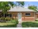 Charming brick bungalow with well-maintained lawn, landscaped garden, and inviting entrance at 8991 Hickory Pl, Thornton, CO 80229