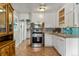 Functional kitchen with stainless steel appliances, white cabinetry, and tile backsplash at 8991 Hickory Pl, Thornton, CO 80229