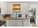 Well-lit kitchen featuring white cabinetry and stainless steel appliances at 8991 Hickory Pl, Thornton, CO 80229