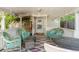 Relaxing covered porch featuring comfortable seating with an array of pillows at 8991 Hickory Pl, Thornton, CO 80229