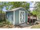 Backyard storage shed with white trim and lawn, perfect for outdoor tools and equipment at 8991 Hickory Pl, Thornton, CO 80229