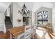 Elegant dining room with staircase, large window, chandelier, and bright, natural light at 4321 Old Windmill Way, Castle Rock, CO 80109