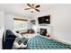 Comfortable living room featuring a fireplace, ceiling fan, decorative rug, sofa, and sunlit window at 4923 Pinon Dr, Elizabeth, CO 80107