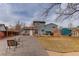 Large backyard with gravel patio, grass, and fire pit at 614 Glenwood Dr, Lafayette, CO 80026