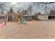 Sandy playground area with playset and shed at 614 Glenwood Dr, Lafayette, CO 80026