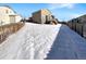 Snow-covered backyard with a wooden fence at 26226 E Canal Pl, Aurora, CO 80018