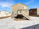 Home's back with a deck and stairs leading to the ground at 26226 E Canal Pl, Aurora, CO 80018