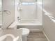 Bathroom with bathtub, toilet, and light wood tile floor at 26226 E Canal Pl, Aurora, CO 80018