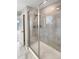 Shower with glass enclosure and gray tile at 26226 E Canal Pl, Aurora, CO 80018