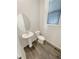 Powder room with pedestal sink and toilet at 26226 E Canal Pl, Aurora, CO 80018