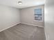 Simple carpeted bedroom with window and neutral walls at 26226 E Canal Pl, Aurora, CO 80018