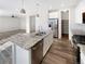 Kitchen island with granite countertop and stainless steel dishwasher at 26226 E Canal Pl, Aurora, CO 80018