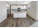 Modern kitchen with island, granite counters, and stainless steel appliances at 26226 E Canal Pl, Aurora, CO 80018