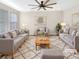 Virtually staged living room featuring gray sofas, a coffee table, and a neutral color palette at 26226 E Canal Pl, Aurora, CO 80018