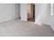 Cozy bedroom featuring plush carpeting and a view into the ensuite bathroom at 24740 E 39Th Ave, Aurora, CO 80019
