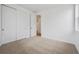 Cozy bedroom featuring plush carpet, white walls, and a spacious closet for storage at 24740 E 39Th Ave, Aurora, CO 80019