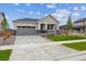Inviting single-story home with a gray exterior, neat landscaping, and a spacious driveway at 24740 E 39Th Ave, Aurora, CO 80019