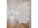 Bright hallway featuring hardwood floors, neutral paint, and access to multiple rooms at 24740 E 39Th Ave, Aurora, CO 80019