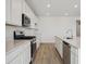 Modern kitchen features stainless steel appliances, white cabinets and a large island at 24740 E 39Th Ave, Aurora, CO 80019