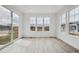 Bright living room featuring a wall of windows with a sliding glass door and hardwood floors at 24740 E 39Th Ave, Aurora, CO 80019