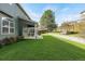 Spacious backyard featuring a well-maintained lawn, stone accents, and a cozy swing, offering an inviting outdoor space at 5149 S Genoa Ct, Centennial, CO 80015