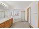 Well-lit main bathroom featuring a double vanity, soaking tub, and glass shower enclosure at 5149 S Genoa Ct, Centennial, CO 80015