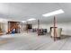 Spacious basement featuring carpet, structural posts, and drop ceiling with fluorescent lighting at 6310 W County Road 4, Berthoud, CO 80513